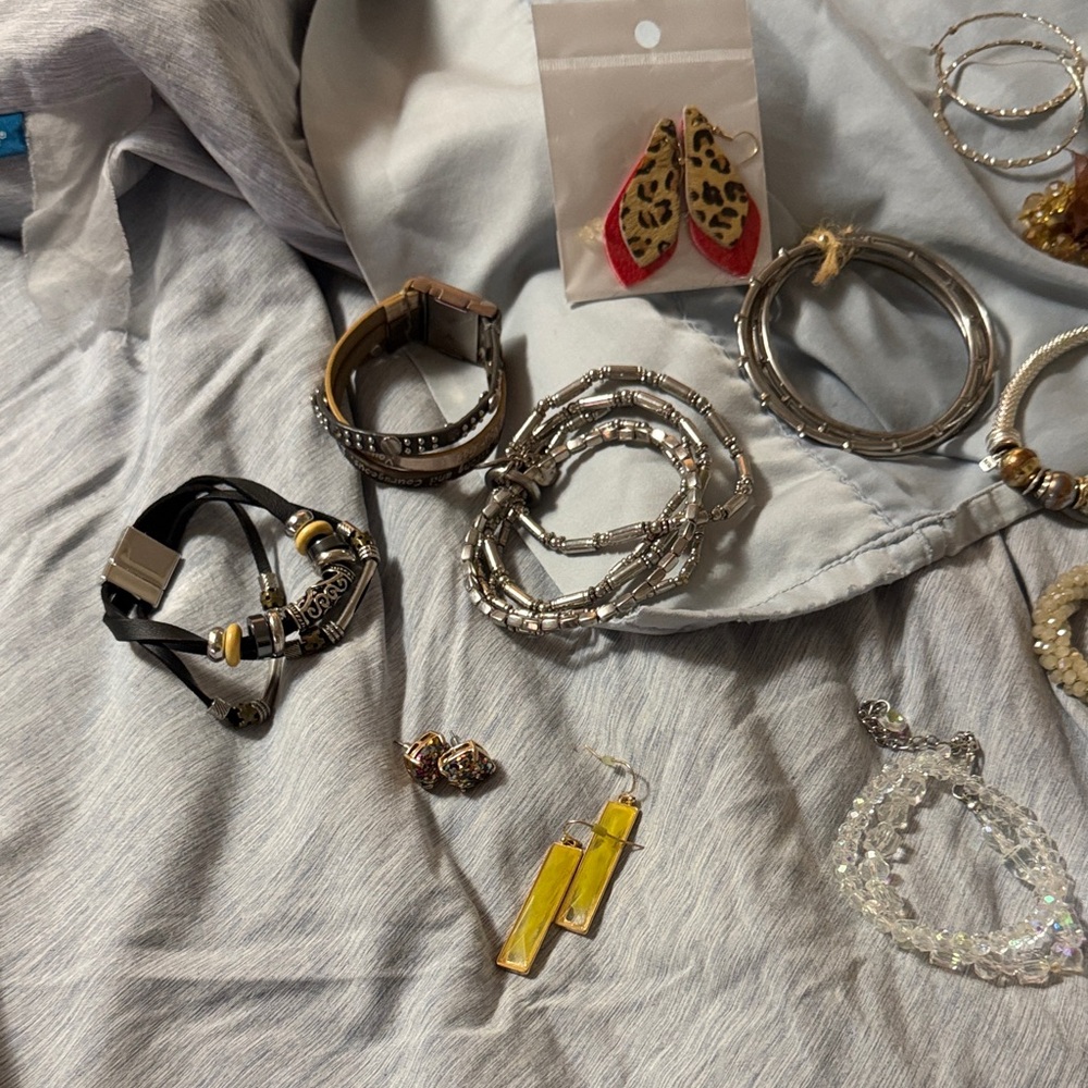 Silver and Gold Women's Bracelet Set. Several bracelets and earrings.